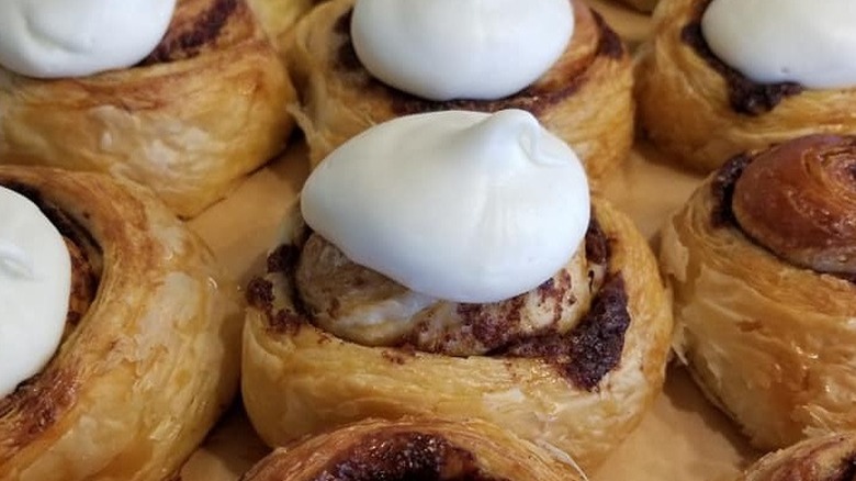 Several cinnamon rolls topped with pillowy icing