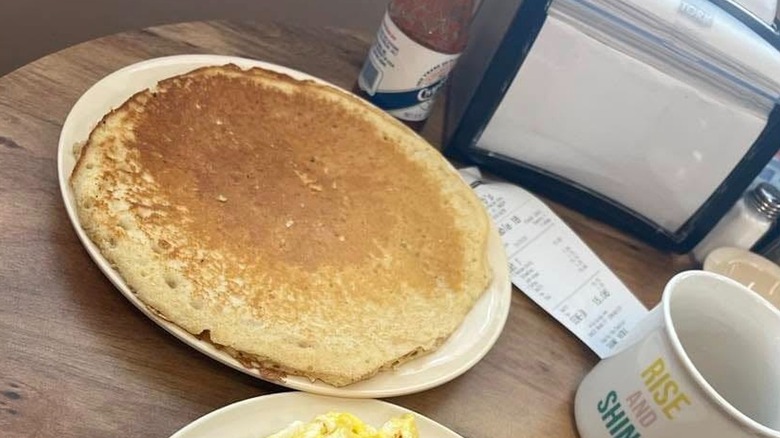 Large pancake on white plate at Barb's Country Kitchen
