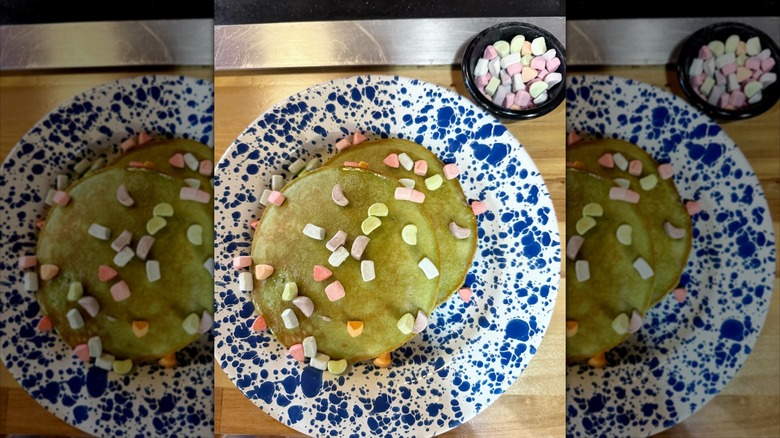 Top-down view of Lucky Charms pancakes on blue and white plate