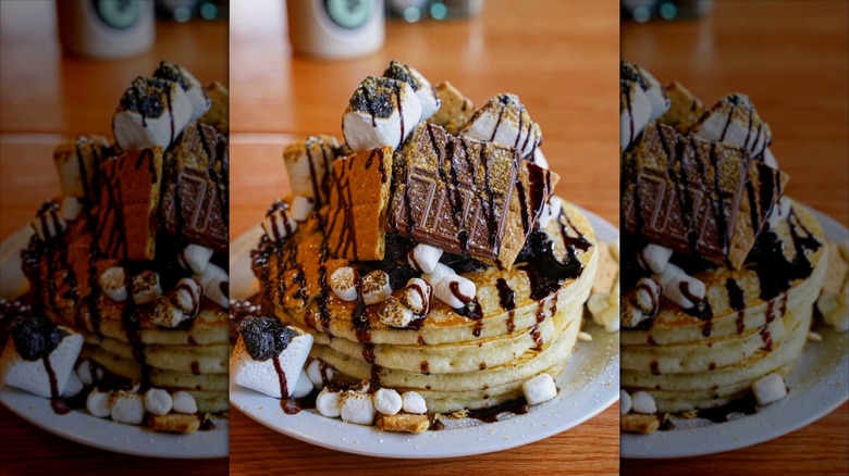 Stack of s'mores pancakes on white plate