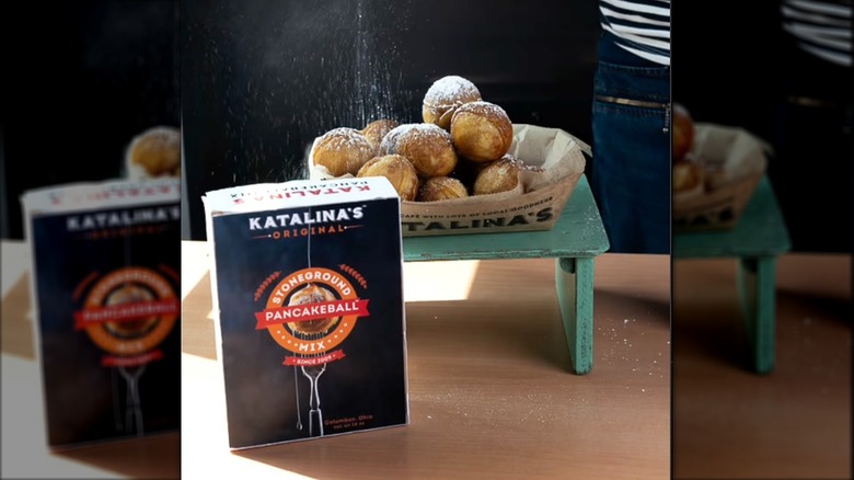 Basket of pancake balls behind box of Katalina's pancake ball mix on table