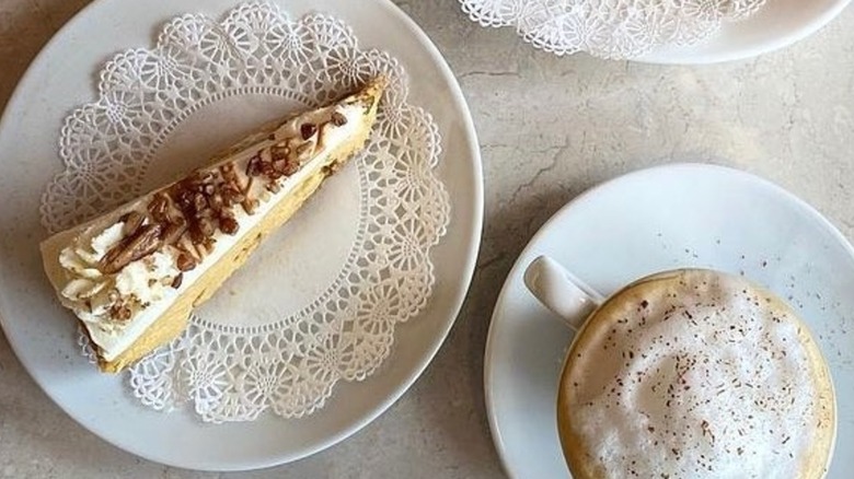 Top-down shot of pumpkin cheesecake on white plate with doily