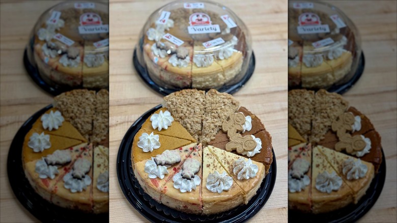 Different cheesecakes arranged into whole cake on black plate