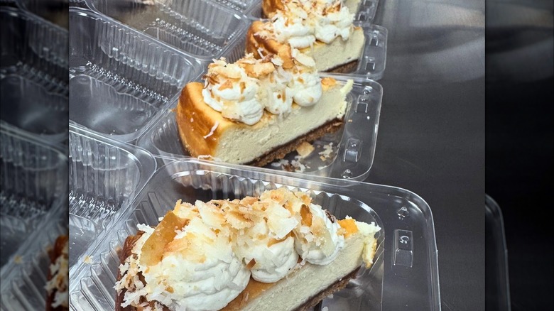 Slices of coconut cheesecake in plastic takeout containers