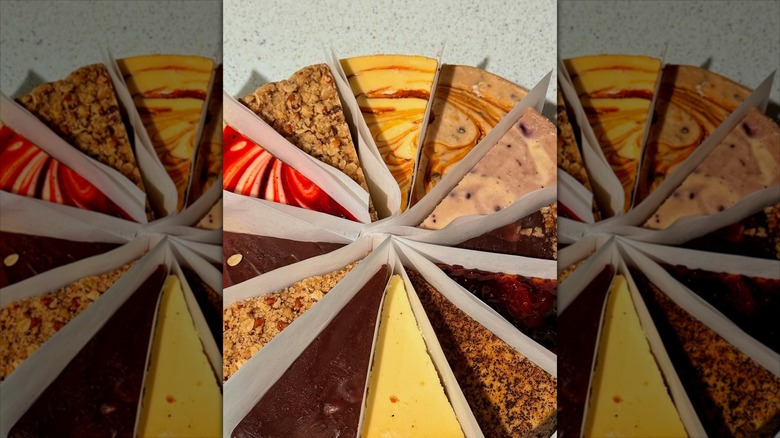 Variety of cheesecake slices arranged into round and separated by paper