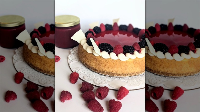 Cheesecake topped with berries and lined with whipped cream swirl