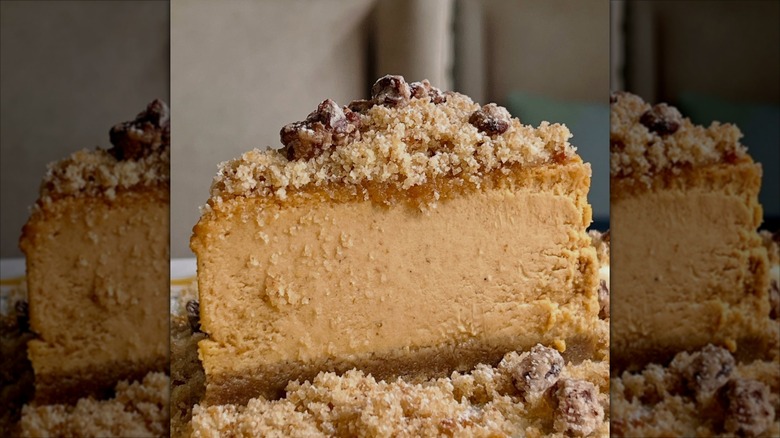 Close-up of slice of pumpkin cheesecake with crumble topping  and chocolate pieces