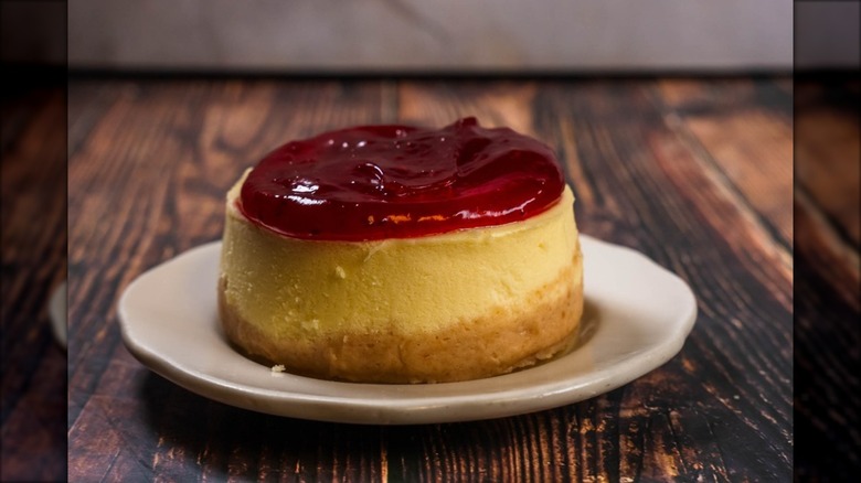 Close-up of cheesecake with thick red berry gel topping