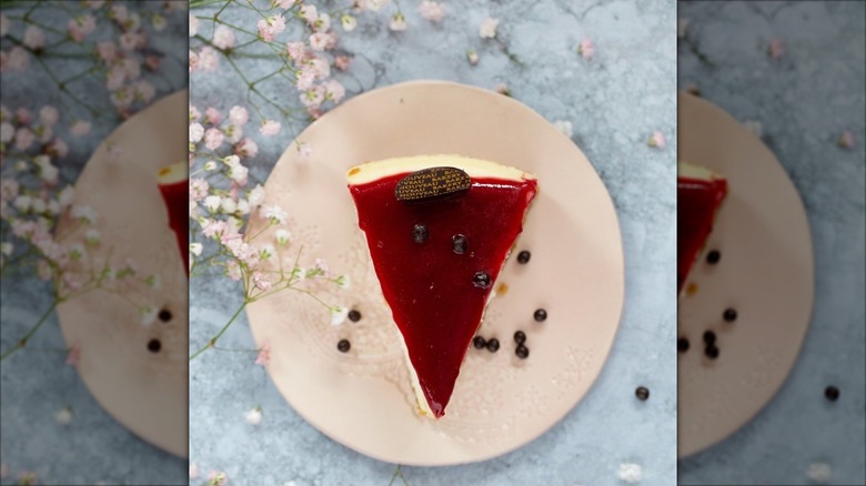 Top-down slice of cheesecake with red gel topping