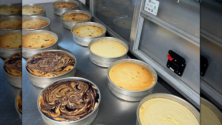 Several cheesecake rounds on steel countertop