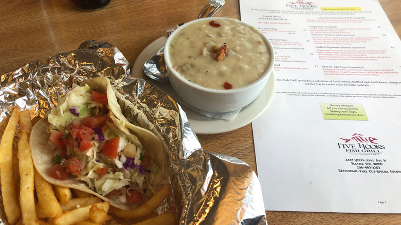 Fish taco basket with fries and a clam chowder on the side with a menu