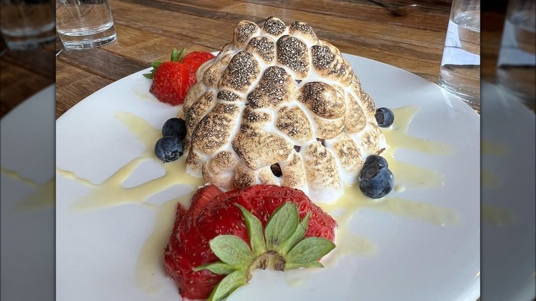 Baked Alaska on plate with blueberries and strawberries