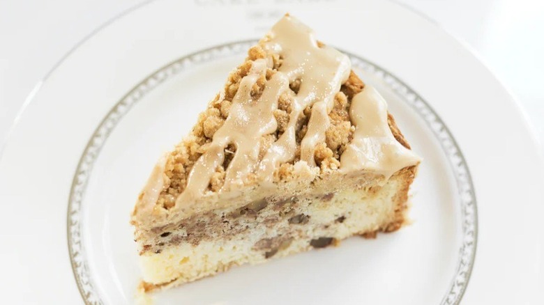 Slice of maple walnut crumb cake on plate