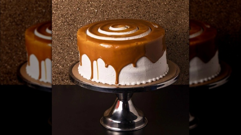 Whole vanilla cream and carmel cake on cake stand