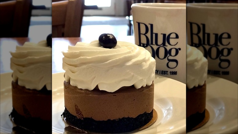 Chocolate mousse cake in front of Blue Dog mug