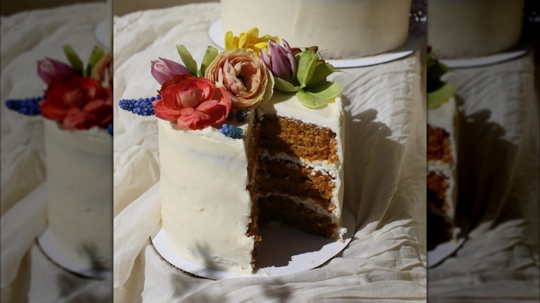 Three layered carrot cake with flowers on top