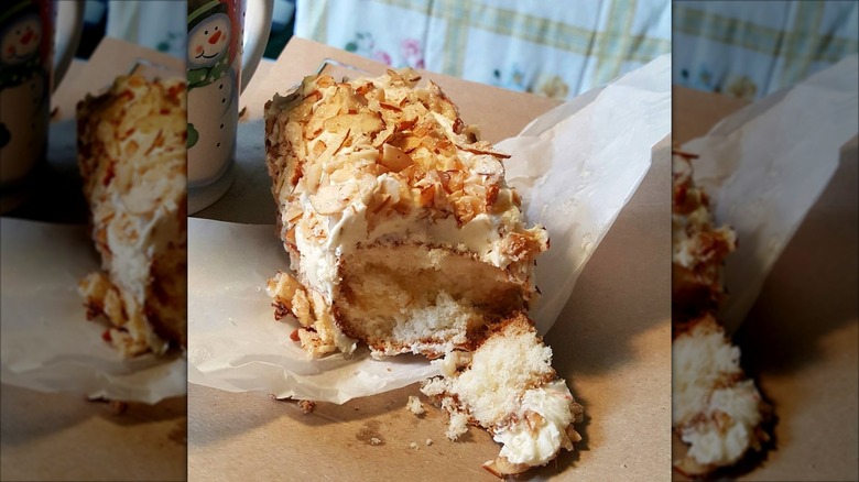 Oblong cake with frosting and sliced almonds on top