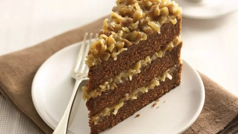 Slice of German chocolate cake on plate with fork