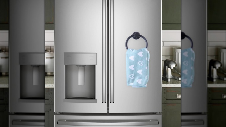 A stainless steel refrigerator with a magnetic towel hoop on the front door