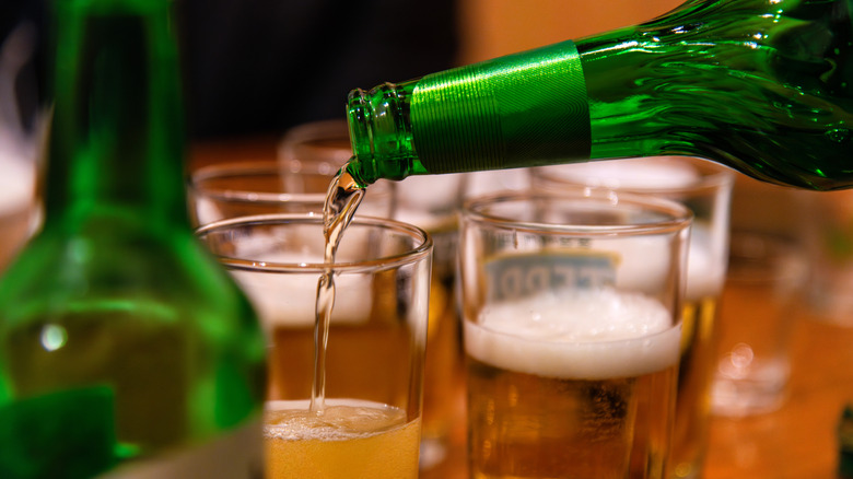 pouring beer from bottle into glass