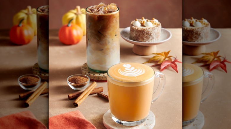 Hot and iced pumpkin lattes from Peet's Coffee on table with cinnamon sticks.