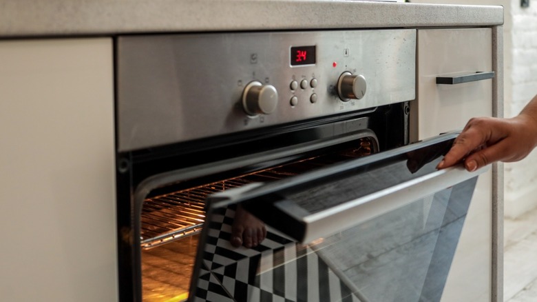 hand opening oven door