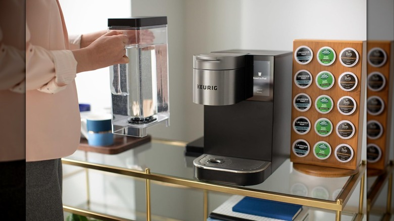 Person holding large water reservoir for Keurig® K-2550