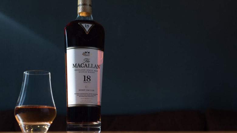 A full bottle of Macallan Sherry Oak 18 Years Old whisky next to a serving in a glass