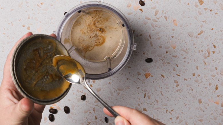 Adding caramel sauce to frappe ingredients in blender
