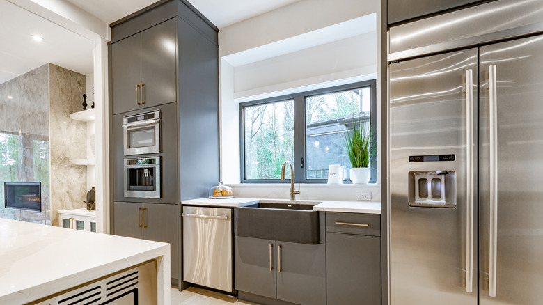 A spacious, modern kitchen outfitted with a French door stainless steel refrigerator