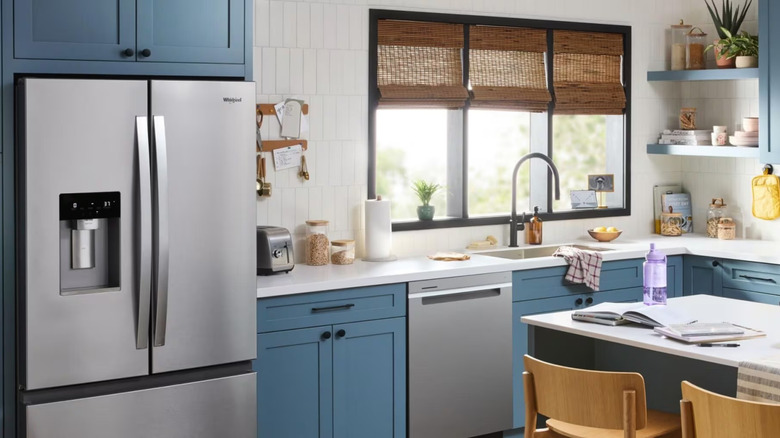 Whirlpool brand appliance in kitchen with blue cabinets