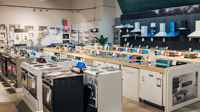 Kitchen appliances for sale displayed in a large store space.