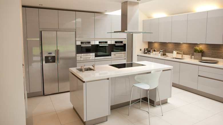 A white kitchen with stainless steel appliances