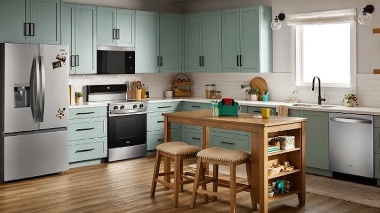 A turquoise open-concept kitchen
