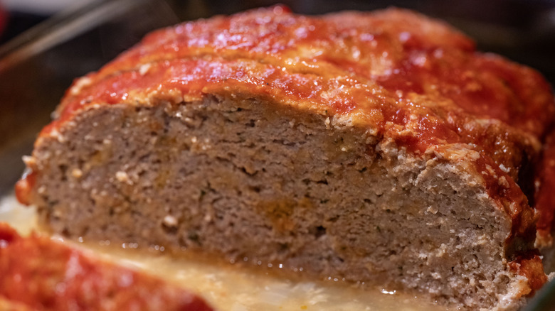 Close-up on a dense meatloaf with a thin ketchup coating on top