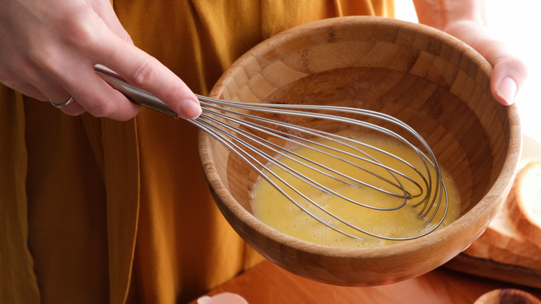 beating scrambled eggs with whisk