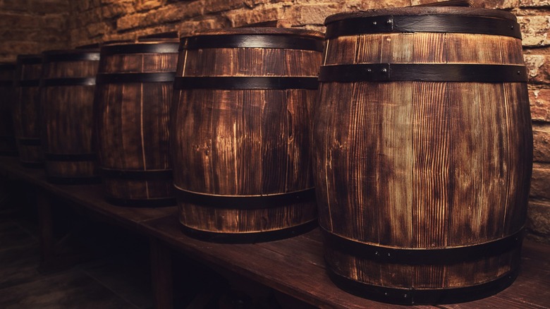 A row of whiskey barrels in a cellar