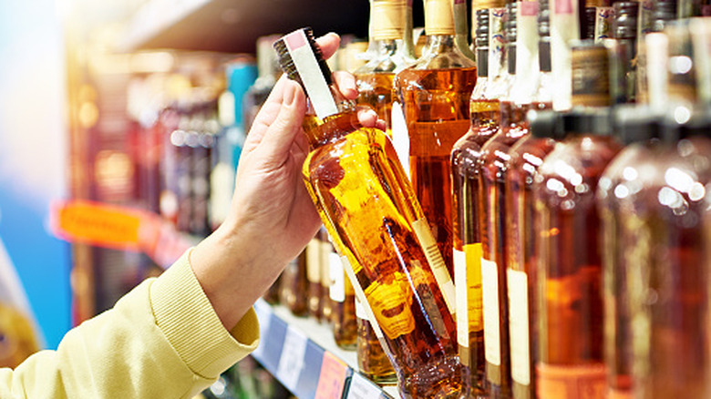 multiple bottles of whiskey on a store shelf