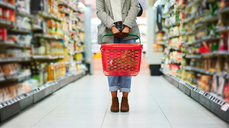 Grocery shopper holding a basket
