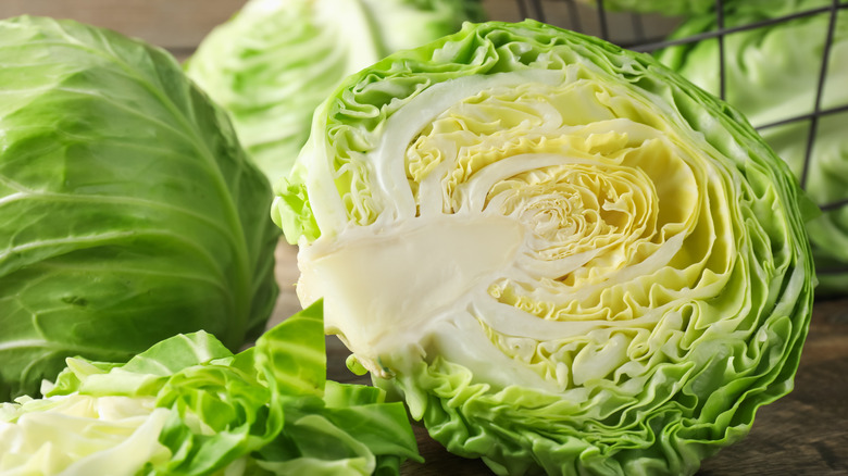 Close-up of a head of green cabbage cut in half.