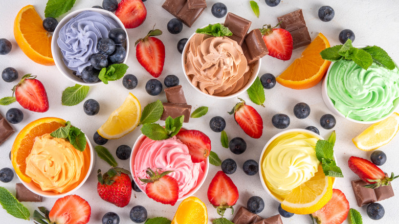 Various frozen yogurt flavors with fruit toppings