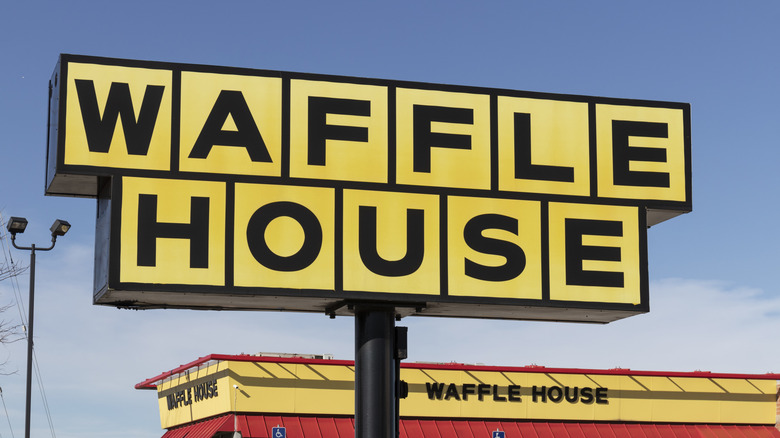 Waffle House sign above the roof of a Waffle House restaurant