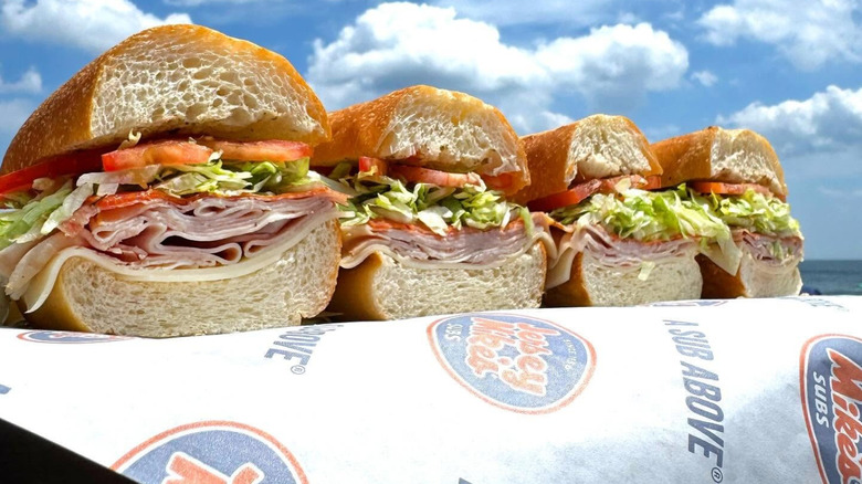 Sliced Jersey Mike's Italian subs in a line outside
