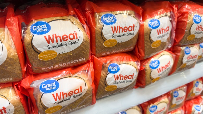 Loaves of Great Value wheat bread on store shelf