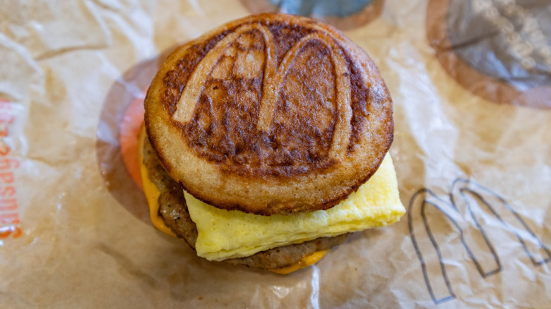 A McGriddle sandwich sits on an open wrapper