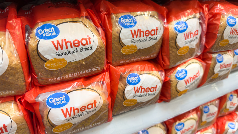 Bags of Great Value Wheat Sandwich bread on a Walmart shelf
