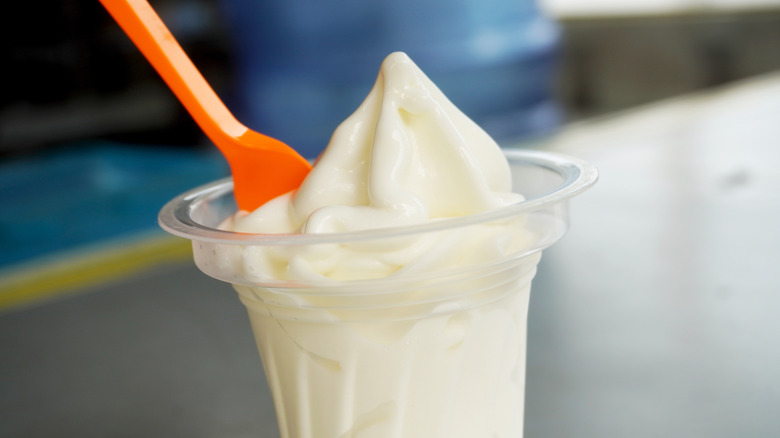 Cup of vanilla soft serve with spoon