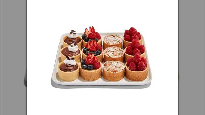 Whole Foods Mini Tart Platter showing four tarts in raspberry, berry, chocolate, and almond flavors
