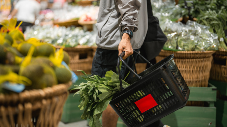 Person shopping for produce supermarket