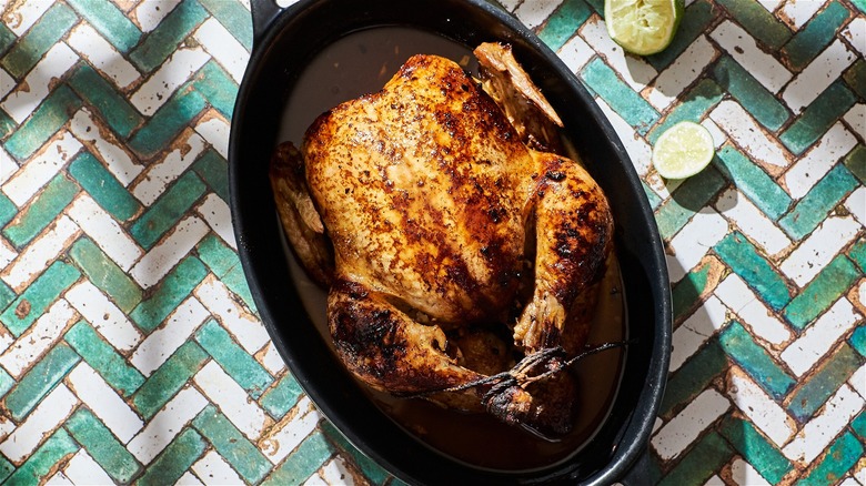 whole roasted chicken in baking dish